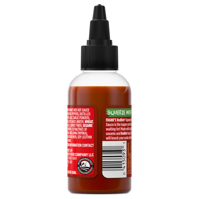 ["A bottle of Frank's RedHot Squeeze Sauce with a black nozzle cap, showcasing the ingredients and product information on the label."]