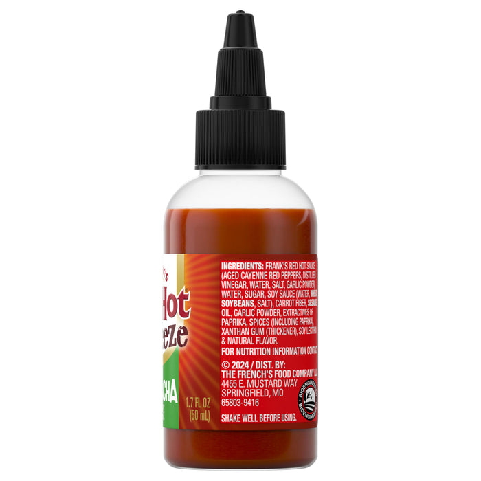 ["A bottle of Frank's RedHot Sriracha sauce shows the ingredients and company information on the label."]