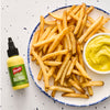 French's Dill Pickle Mustard Spread is featured alongside a plate of golden french fries and a bowl of mustard.