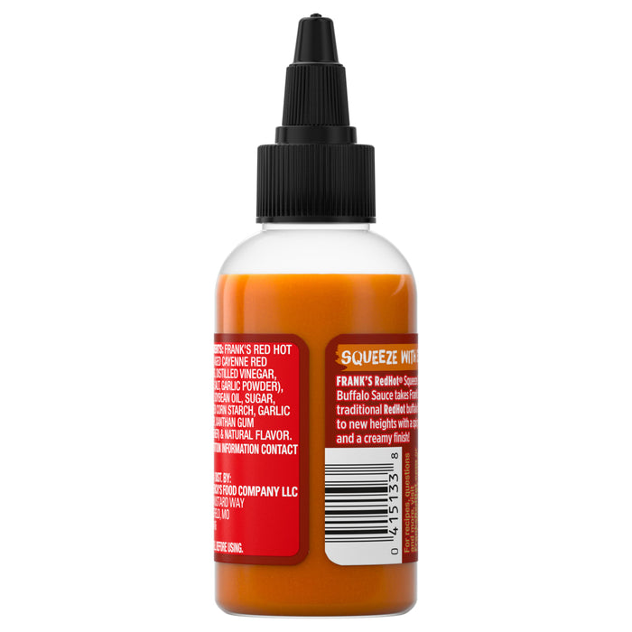 ["A bottle of Frank's RedHot Squeeze Buffalo Sauce with a black cap and a label showing the ingredients and product description."]