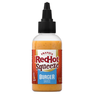 ["A bottle of Frank's RedHot Squeeze Burger Sauce is displayed against a black background."]