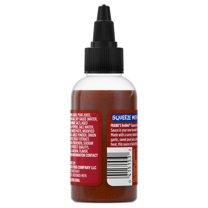 A bottle of Franks RedHot Squeeze Sauce with a black cap and a label detailing the ingredients and product information.