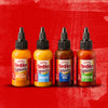 Four bottles of Franks RedHot Squeeze sauce in different flavors: Creamy Buffalo Burger Korean BBQ and Sriracha.