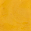 A close-up shot of a smooth vibrant yellow sauce with subtle texture ideal for culinary or food-related content.