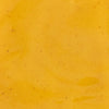 A close-up shot of a smooth vibrant yellow sauce with subtle texture ideal for culinary or food-related content.