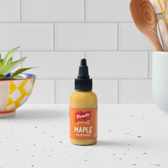 A bottle of French's Maple Mustard sits on a white countertop.