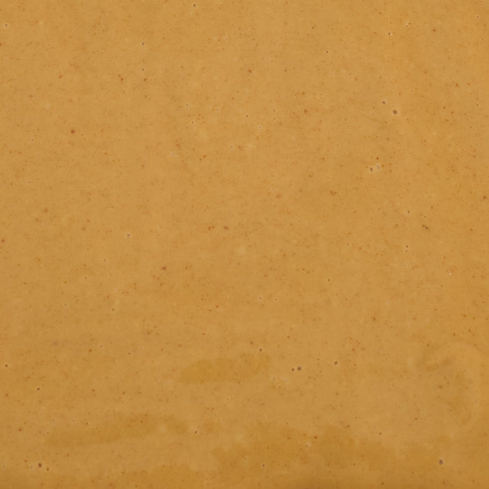 A smooth, tan-colored surface with subtle variations in texture and color.