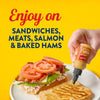 A hand squeezes French's Maple Mustard onto a sandwich with the text "Enjoy on Sandwiches, Meats, Salmon &amp; Baked Hams" on a yellow background.