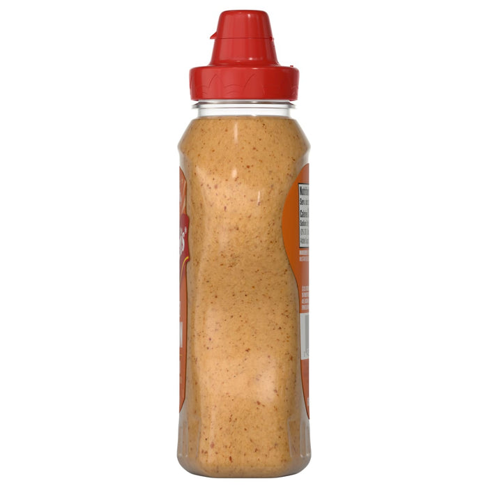 A clear plastic squeeze bottle of French'S Honey Dijon Mustard Gluten Free with a red flip-top cap, showing the light brown, grainy mustard inside and a partial nutrition label on the side.