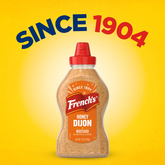 A bottle of Frenchs Brown Honey Dijon Mustard 12 Oz is centered against a bright yellow background with the text SINCE 1904 arched above it.