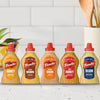 A lineup of five different varieties of Frenchs Brown Honey Dijon Mustard 12 Oz bottles including Honey, Spicy Brown, Honey Dijon, Hot Honey, and Dijon flavors displayed against a white tiled kitchen background.