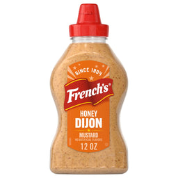 A 12 oz squeeze bottle of Frenchs Brown Honey Dijon Mustard 12 Oz featuring a red flip top cap and a vibrant orange label with the brand logo.
