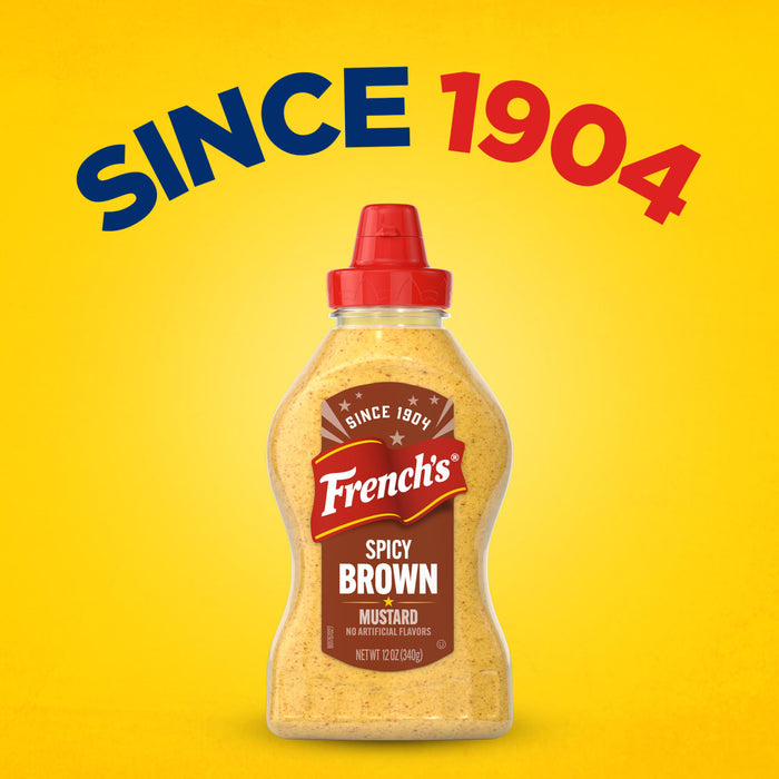 A bottle of French's Spicy Brown Mustard is centered on a yellow background with the words Since 1904, representing the quality found in products like Frenchs Dill Pickle Sandwich Spread Regular Inverted Squeeze Bottle Rp 12 Oz.
