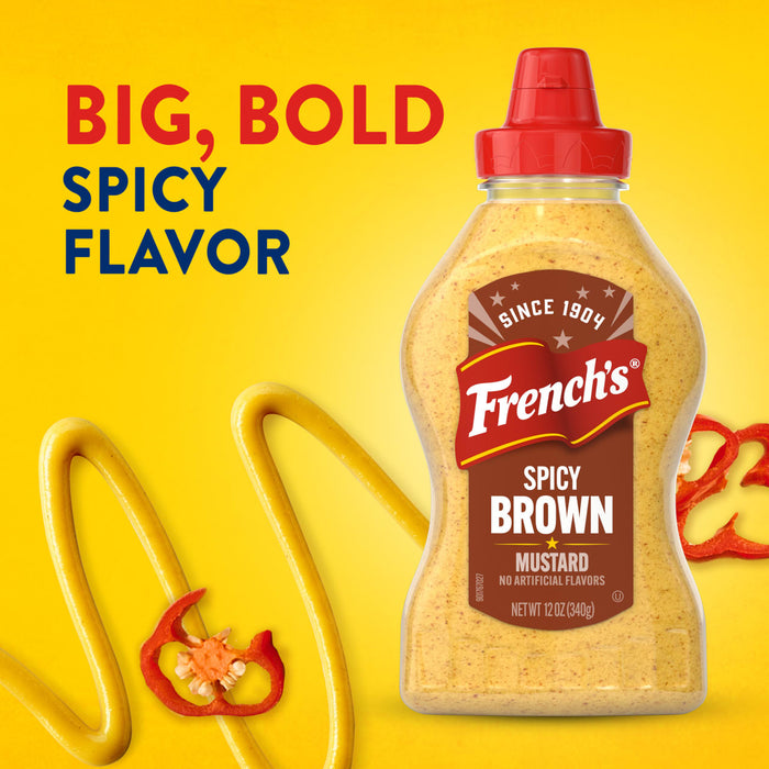 A bottle of Frenchs Brown Spicy Brown Mustard 12 Oz is shown in an advertisement against a vibrant yellow background, accompanied by swirls of mustard and slices of red chili peppers to emphasize its big, bold, and spicy flavor.