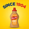 A bottle of Frenchs Brown Honey Mustard 12 Oz is centered on a bright yellow background, with the words SINCE 1904 arched above it.