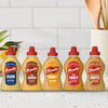 A lineup of five French's mustard varieties, including Dijon, Spicy Brown, and Honey, are displayed on a kitchen counter to showcase the brand's range, which features products like Frenchs Brown Honey Mustard 12 Oz.
