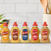 A product lineup of five different French's mustards, including the Frenchs Beige Dijon Chardonnay Mustard 12 Oz, is arranged on a kitchen counter to showcase the variety of flavors.