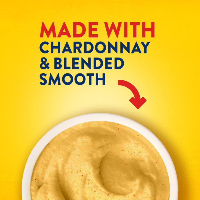 A red arrow points from the text MADE WITH CHARDONNAY &amp; BLENDED SMOOTH to a white bowl filled with the creamy Frenchs Beige Dijon Chardonnay Mustard 12 Oz, emphasizing its quality ingredients and texture.