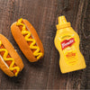 ["Two hot dogs with mustard and a bottle of French's Classic Yellow Mustard."]