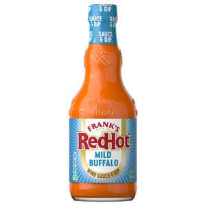 A glass bottle of Franks Red Hot Regular Wing Hot Sauce Mild 12 Oz is shown against a white background, highlighting its orange color and blue label.