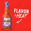 A bottle of Franks Red Hot Garlic Buffalo Wing Hot Sauce Regular 12 Oz is displayed against a vibrant red background with the words FLAVOR and HEAT and a white arrow pointing to the medium heat level indicator on the label.