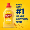A bottle of Frenchs Yellow Regular Mustard 12 Oz stands against a bright yellow background featuring the text Made With Number 1 Grade Mustard Seed and scattered whole mustard seeds.