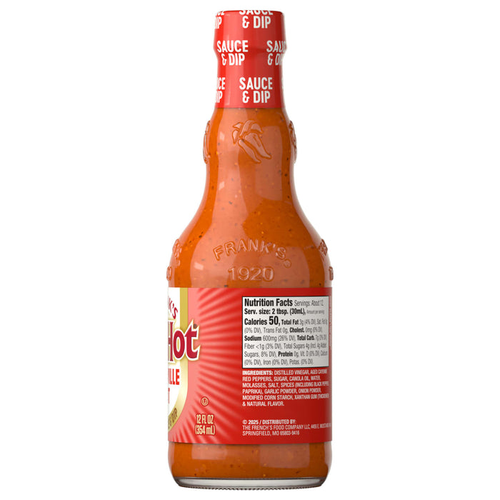 A glass bottle of Franks Red Hot Regular Wing Hot Sauce Hot 12 Oz is shown against a white background, with the nutrition facts and ingredients label facing forward.