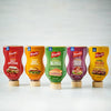 Five different flavors of French's mustard are shown in squeeze bottles.