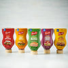 Five different flavors of French's mustard are shown in squeeze bottles.