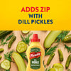 A bottle of Frenchs Dill Pickle Sandwich Spread Regular Inverted Squeeze Bottle Rp 12 Oz is shown on a wooden board surrounded by fresh dill pickles and dill sprigs, under text that reads, Adds zip with dill pickles.