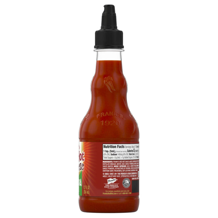 ["A bottle of Frank's RedHot Sriracha sauce with the nutrition facts and ingredients label visible."]