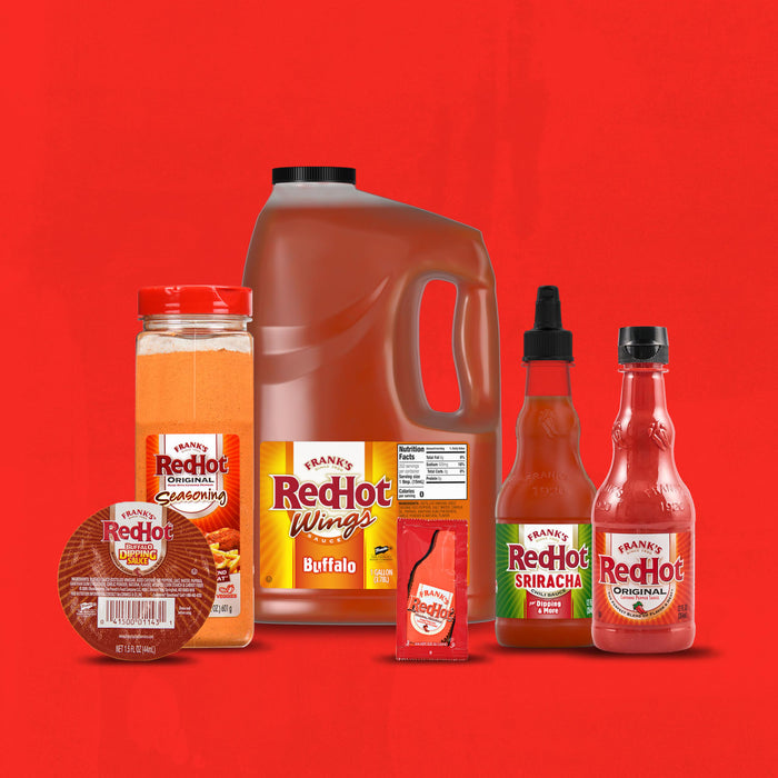 A collection of Frank's RedHot products, including a bottle of buffalo wing sauce, a jar of seasoning, and two bottles of hot sauce.