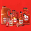 A collection of Frank's RedHot bottles of different sizes.