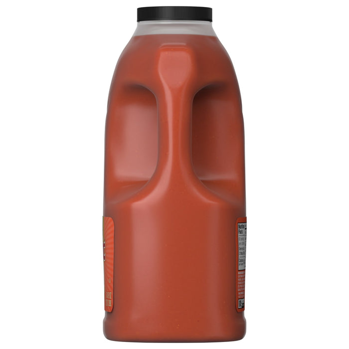 A side view of a large jug of Franks Red Hot Mango Habanero Wing Hot Sauce Regular 64 Oz, showing the built-in handle and the nutrition facts label.