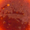 A close-up shot of a vibrant textured tomato sauce.
