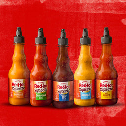 Six bottles of Franks RedHot Squeeze sauce in different flavors.