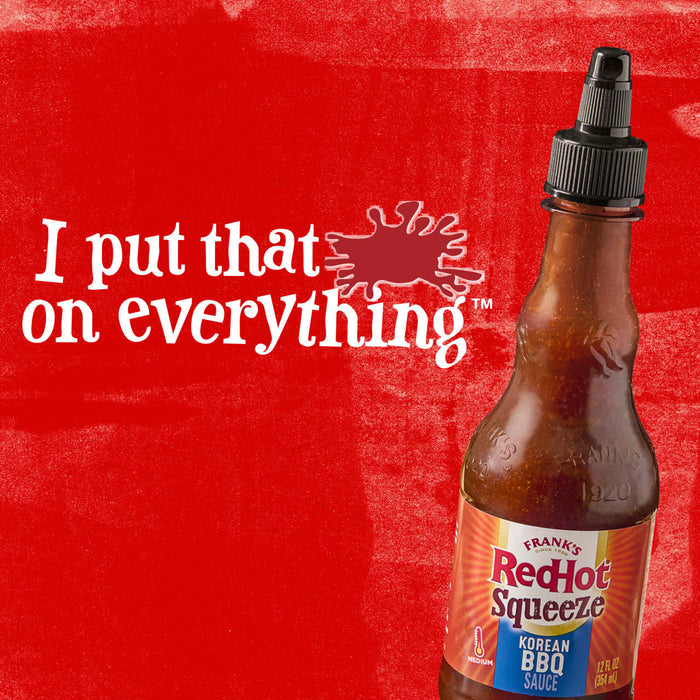 A bottle of Frank\s RedHot Squeeze Korean BBQ Sauce on a red background with the text I put that on everything.