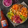A bowl of Korean BBQ salmon rice bowl with Franks RedHot Squeeze Korean BBQ Sauce.