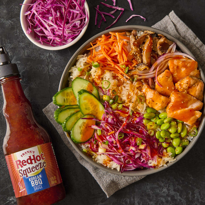 A bowl of Korean BBQ salmon rice bowl with Franks RedHot Squeeze Korean BBQ Sauce.
