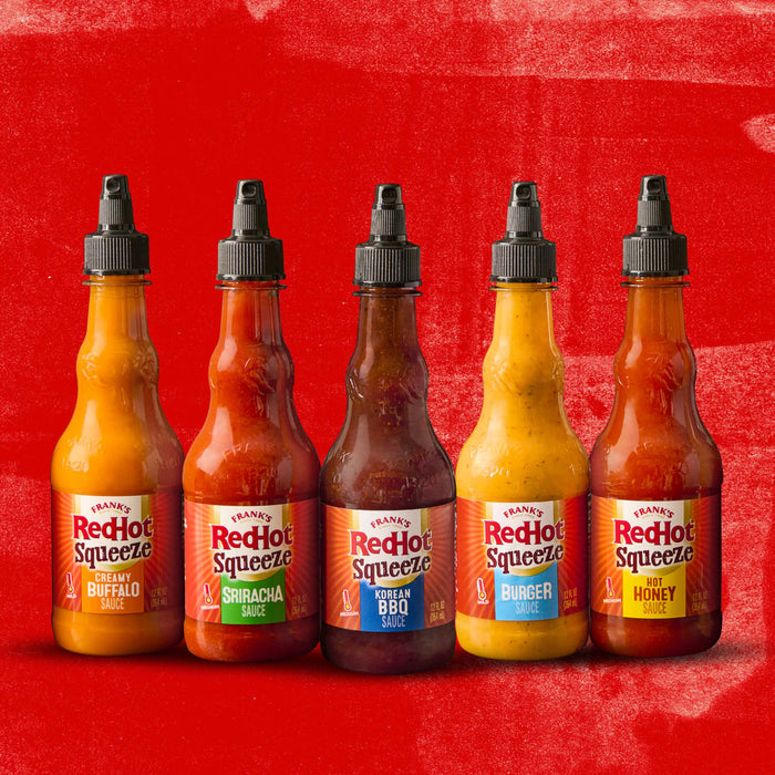 Six bottles of Franks RedHot Squeeze sauce in different flavors.