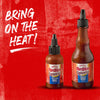Two bottles of Franks RedHot Squeeze Korean BBQ sauce on a red background.