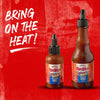 Two bottles of Franks RedHot Squeeze Korean BBQ sauce on a red background.