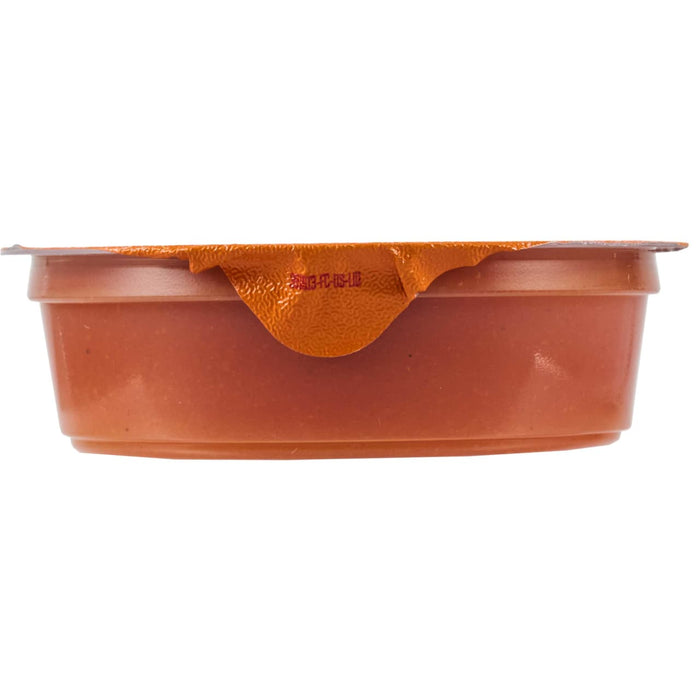 A sealed container of what appears to be a food product, possibly a dip or sauce, ready for consumption.
