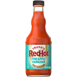 A bottle of Frank'S Redhot Pineapple Hawaiian Wings Sauce 12 Fl Oz is shown, filled with a bright orange-red sauce and featuring a label with a teal and yellow design.