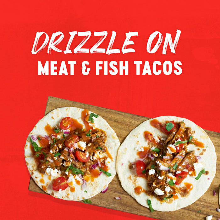 A vibrant image showcasing two tacos filled with meat and fish, drizzled with a flavorful sauce, suggesting a delicious topping option.