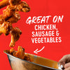 Chicken wings are tossed in a bowl with a sauce that is great on chicken, sausage, and vegetables.