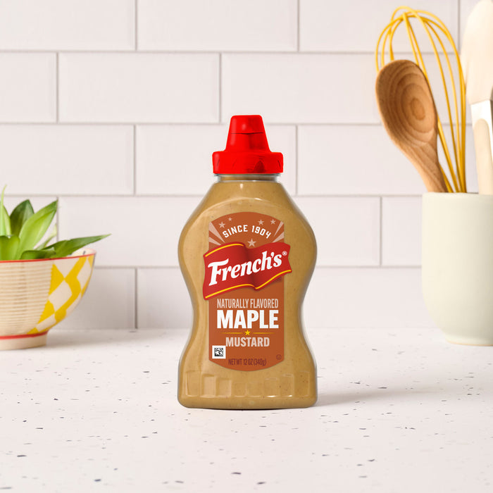 A bottle of French's Sweet &amp; Smoky Maple Mustard sits on a kitchen counter.