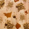 A spilled mixture of brown sugar and liquid creates a sticky mess on a wooden surface.