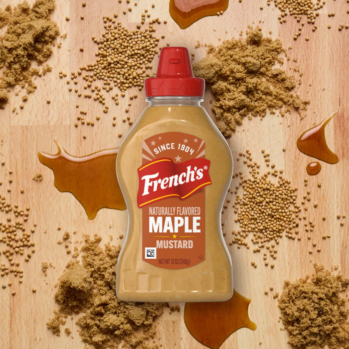 A spilled mixture of brown sugar and liquid creates a sticky mess on a wooden surface.