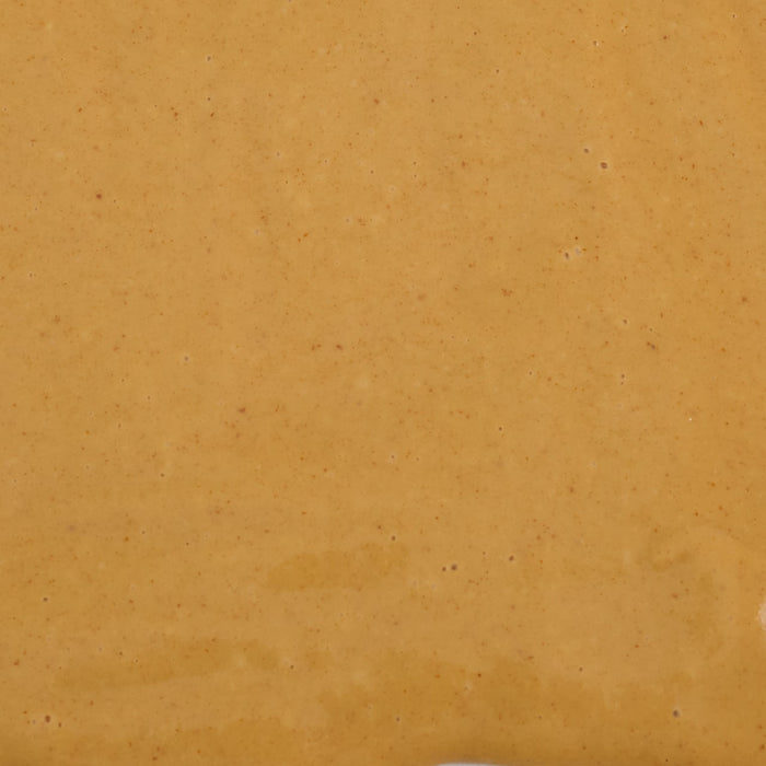 A smooth, creamy, orange-colored sauce.